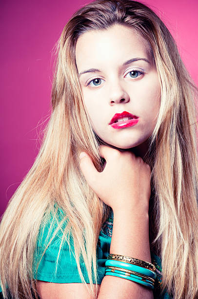 istock Young blonde teen staring on red background 184866650
