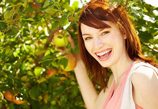 istock Smiling happy woman picking apple 184866866