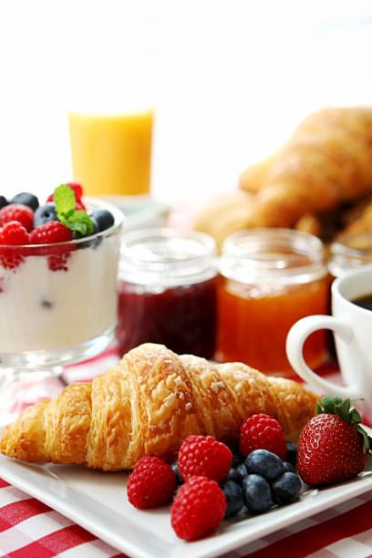 Breakfast of fruit, juice, yogurt, croissant and coffee breakfast- croissant and coffee continental breakfast stock pictures, royalty-free photos & images