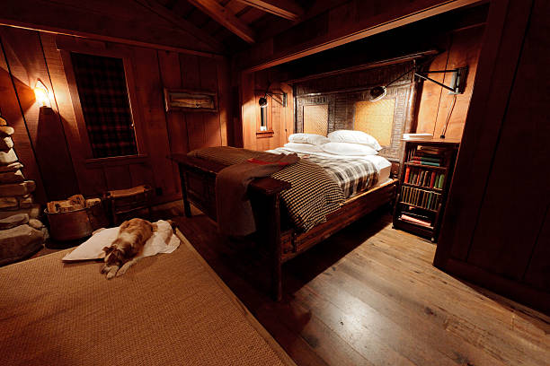 gemütliche schlafzimmer und ein hund - rustic bedroom cabin indoors stock-fotos und bilder
