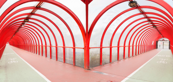 A covered path divided into a pedestrian lane (red lane) and a cycle lane (green lane).