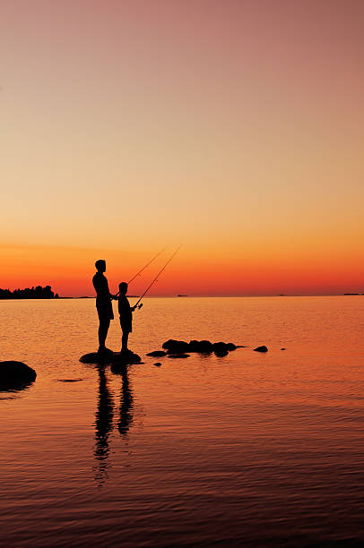istock Boys Are Fishing At Sunset - I 184867482