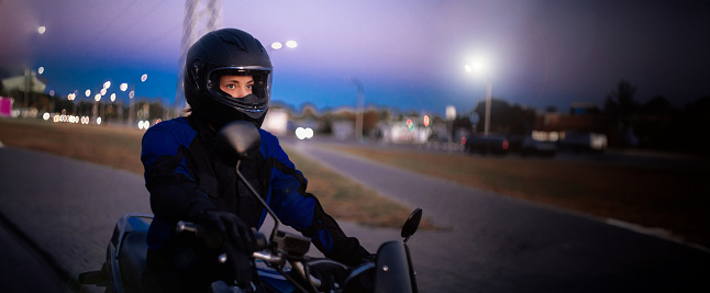 female motorcyclist in a motorcycle jacket and helmet. beautiful woman on a motorcycle
​