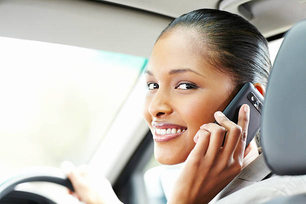istock Businesswoman Using a Cellphone in the Car 184867983