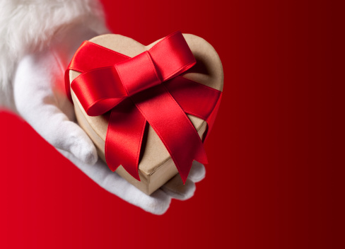 Hand of Santa Claus with heart-shaped gift.Similar photographs from my portfolio: