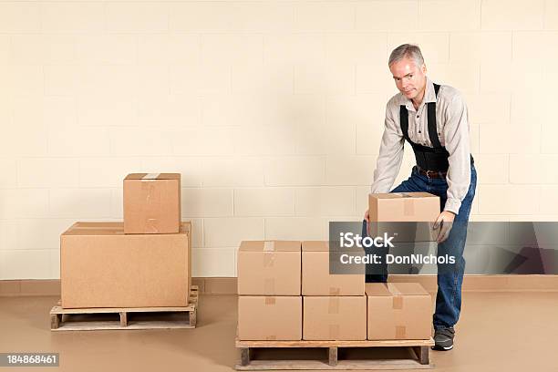 Worker Wearing A Back Brace Stock Photo - Download Image Now - Picking Up, Back, Rear View