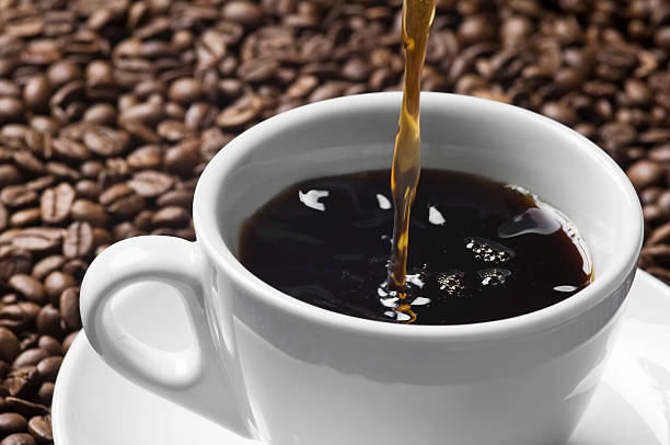 istock Pouring stream of brown coffee to white cup 184868677