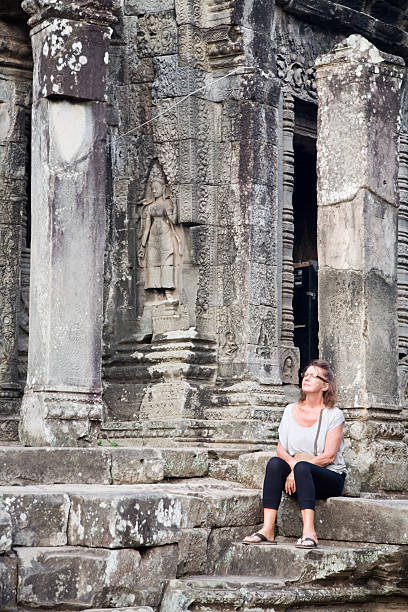 istock Woman in Bayon temple Angkor 184869314