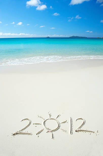 istock Bright 2012 Message with Sun on Vibrant Tropical Beach 184869391