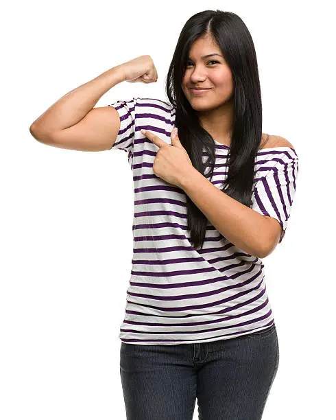 Photo of Confident Young Woman Flexes Bicep