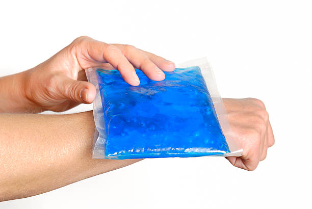 gel pack on wrist "Cool gel pack on a swollen hurting wrist.doctor, pain, injury and medicine" physical injury sport ice pain stock pictures, royalty-free photos & images