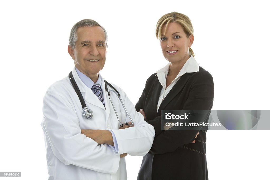 Senior male doctor with businesswoman arms crossed "Senior male wearing lab coat and stethoscope with mid adult female in a business suit, isolated on white background, copy space" 30-39 Years Stock Photo