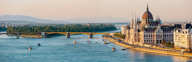 panoramic view of budapest, hungary with the hungarian parliament building and the danube river. - budapest chain bridge panoramic hungary imagens e fotografias de stock