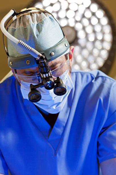 Surgeon with Magnified glasses stock photo