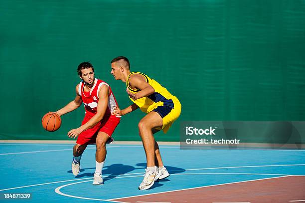 Two Young Basketball Players At Dribbling Action Stock Photo - Download Image Now - 18-19 Years, 30-39 Years, Active Lifestyle