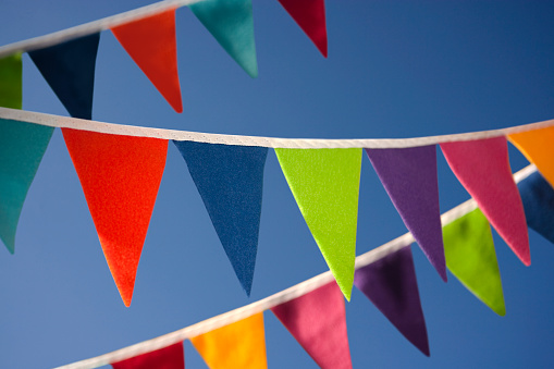 Colourful bunting against a blue summer sky. Shallow depth-of-field.