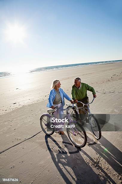 Senior Couple With Bicycles On Beach Stock Photo - Download Image Now - High Angle View, Couple - Relationship, Cycling