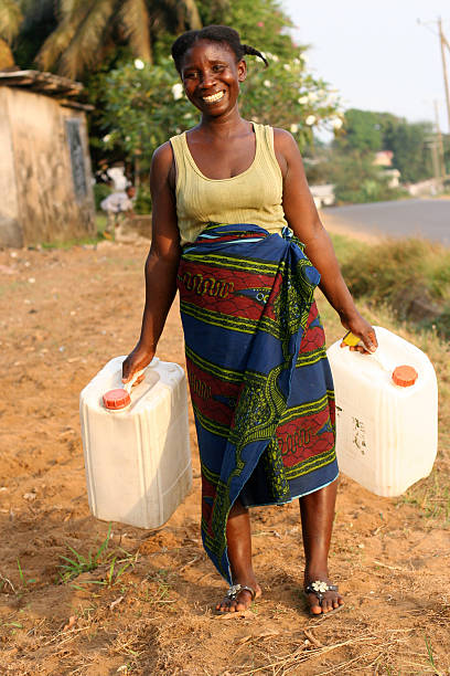 istock African Woman with Water Jugs 184871662