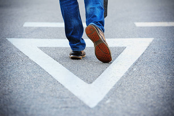 istock Hit the road...Triangle painted on asphalt 184871785