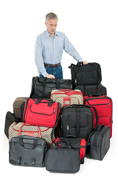 istock Man Overwhelmed With Luggage 184871793