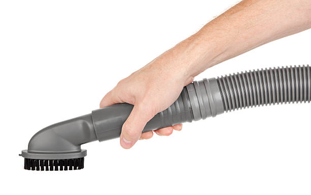istock Hand Holding Vacuum Cleaner Hose 184871884