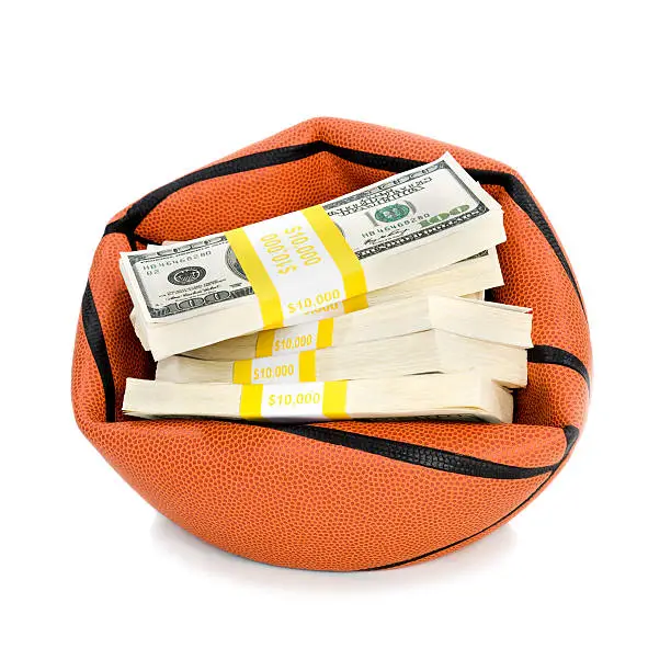 Concept-NBA Lockout. Basketabll crushed by bundles of $100 bills