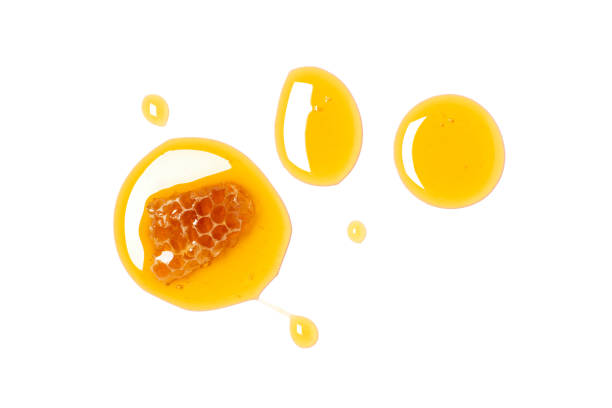 istock Honey drop with honeycomb isolated on white 1848721779