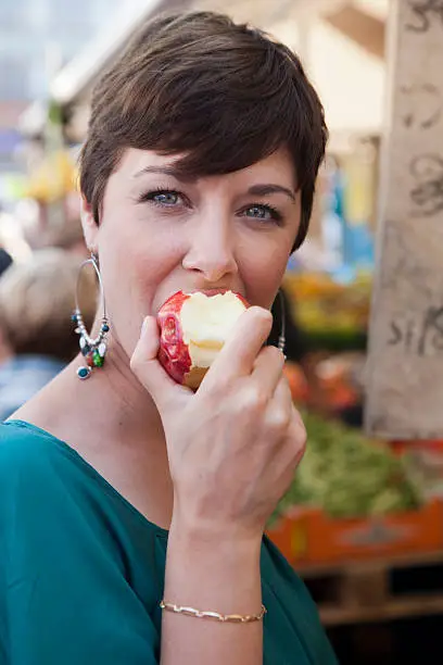 young woman having a healthy bite from an apple