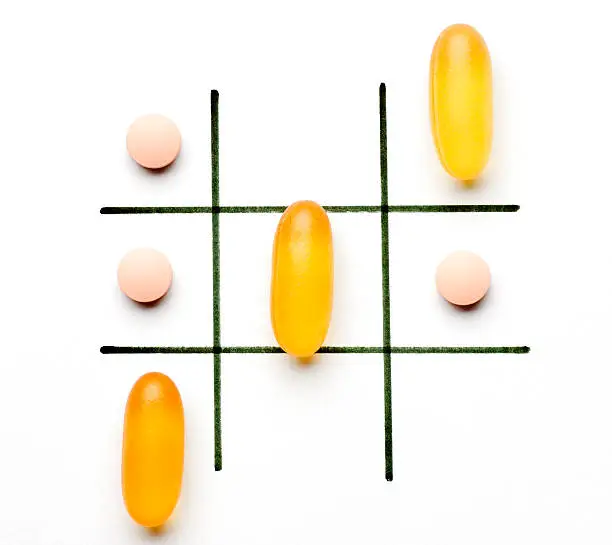 Fish oil and statin drug pill used in a came of tic tac toe