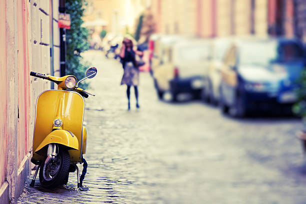 Vespa Scooter in Rome, Italy "Italian urban scene with a Vespa, a very typical italian motorcycle, tilt shift lens" cobblestone photos stock pictures, royalty-free photos & images