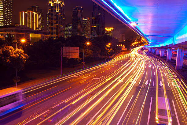 Modern urban city at night with freeway traffic