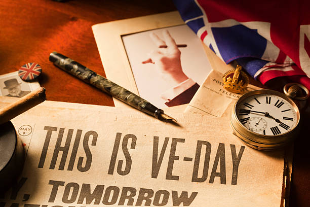 This is VE Day "Itaas Tuesday May the 8th 1945 and itaas VE Day - aEVictory in Europeaa Day for World War II. Winston Churchill broadcasts the news to the nation. Unconditional surrender was signed by Germany on the preceding day at the time displayed by the watch, 2.41pm." winston churchill prime minister stock pictures, royalty-free photos & images