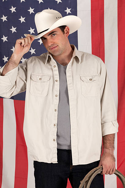 istock Cowboy in front of American flag 184873521