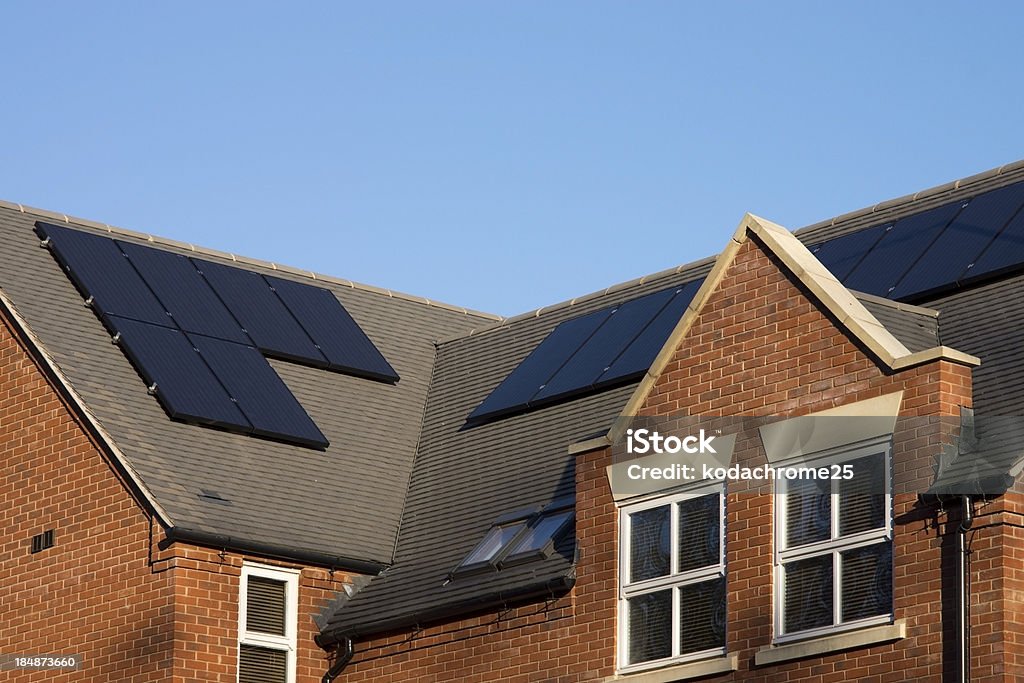 solar panels black photovoltaic solar panels on the roof of newly built flats Solar Panel Stock Photo