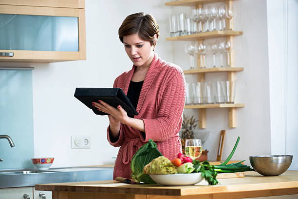 istock Young woman looking at a  Recipe online 184874051