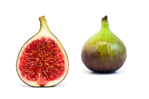 bisected and whole fig fruit isolated on whiteRELATED IMAGES IN THIS
