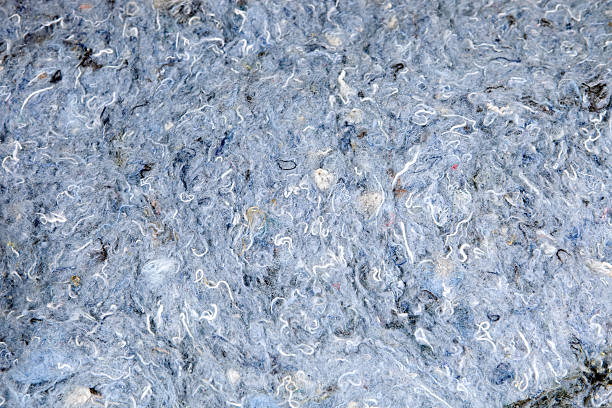 Recycled Blue Jean Denim Insulation Detail A close-up section of recycled blue jean denim insulation which is a new type containing 80% recycled natural fibers and has no fiberglass itch or irritants. Recycled denim is increasing in popularity as a sustainable and clean alternative to fiberglass. recyclable materials stock pictures, royalty-free photos & images