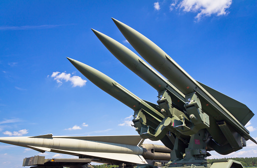 Close-up view of Russian Air to air missile hanging under the wing of fighter aircraft. Soft focus. Military industry theme.