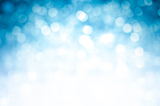 istock Blurred blue sparkles background with darker top corners 184874786