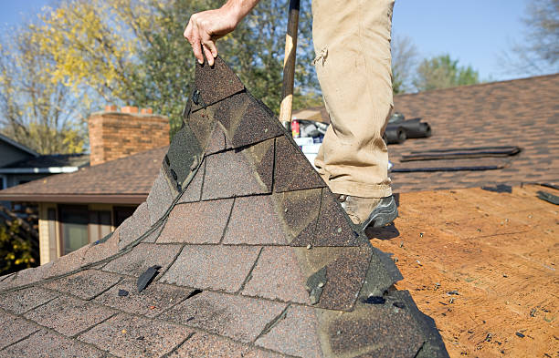 istock Worker Removing Old Roof Shingles for Replacement 184874988