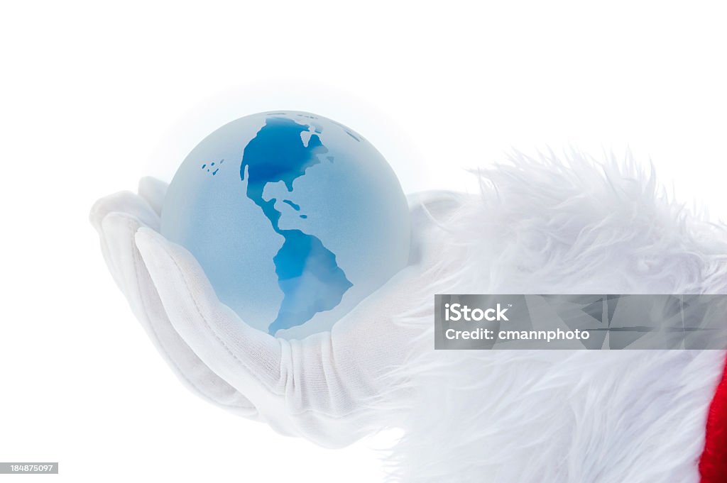 Santa Claus Hand Santa Claus's hand holding a glowing world globe with North and South America showing Santa Claus Stock Photo