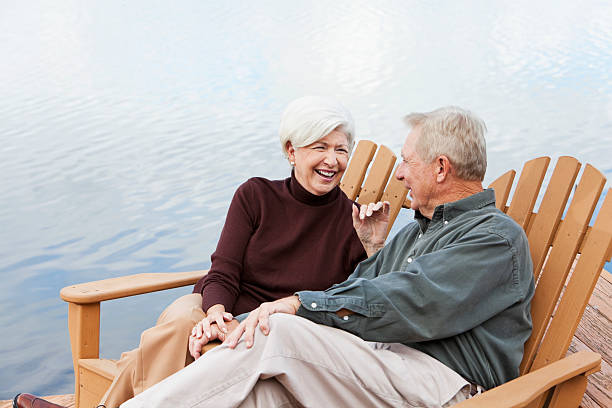 Senior couple sitting by water