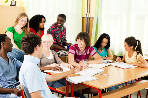 istock Large group of students studying together in the classroom. 184875328