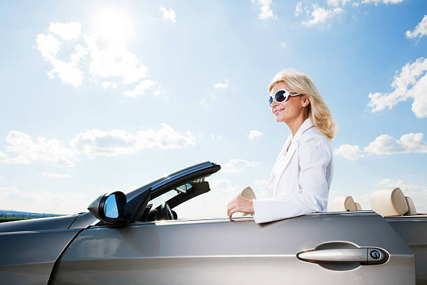 istock Young attractive female is opening her car door. 184875438