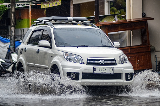 A Daihatsu Terios car crashed into floodwater during heavy rain on a residential street, Indonesia, 8 December 2023.