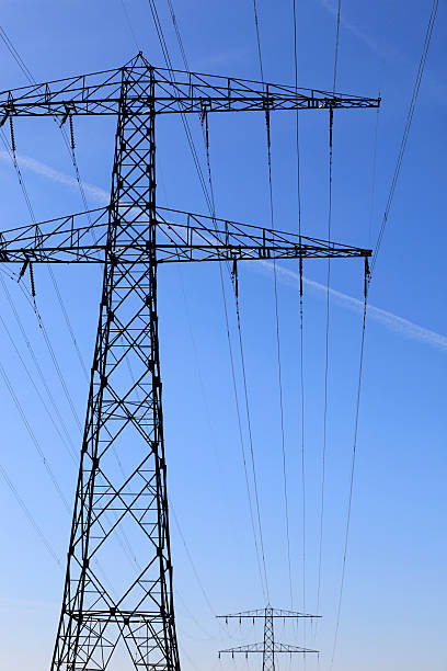istock electricity pylons against a clear blue sky 184875819