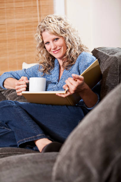 istock Woman reading on couch 184875823