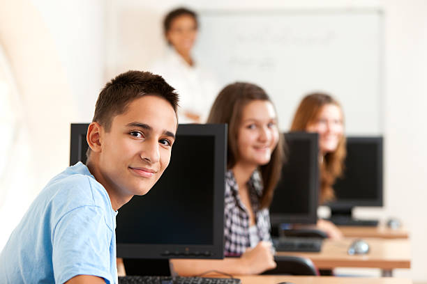 istock School boy with classmates and teacher in the classroom 184875889