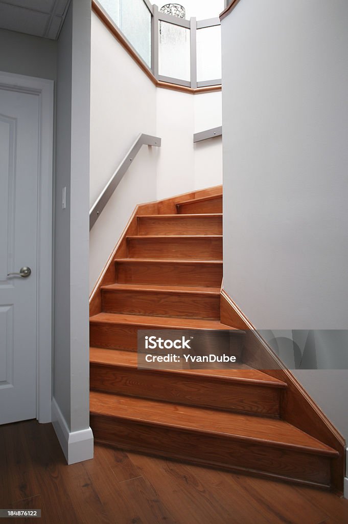 residential staircase hard wood stairway Basement Stock Photo