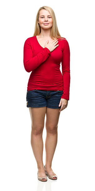 Young Woman Standing With Hand Over Heart